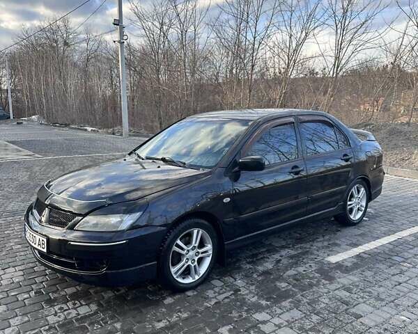 Черный Мицубиси Лансер, объемом двигателя 2 л и пробегом 217 тыс. км за 4600 $, фото 1 на Automoto.ua