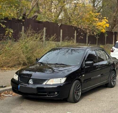 Черный Мицубиси Лансер, объемом двигателя 1.6 л и пробегом 212 тыс. км за 6950 $, фото 1 на Automoto.ua