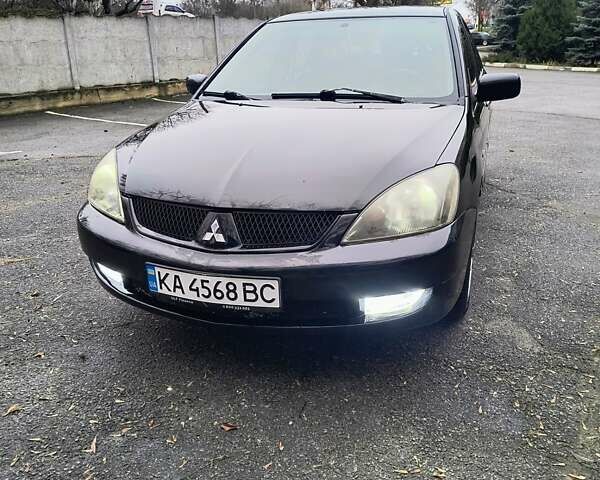 Черный Мицубиси Лансер, объемом двигателя 1.6 л и пробегом 309 тыс. км за 4000 $, фото 1 на Automoto.ua