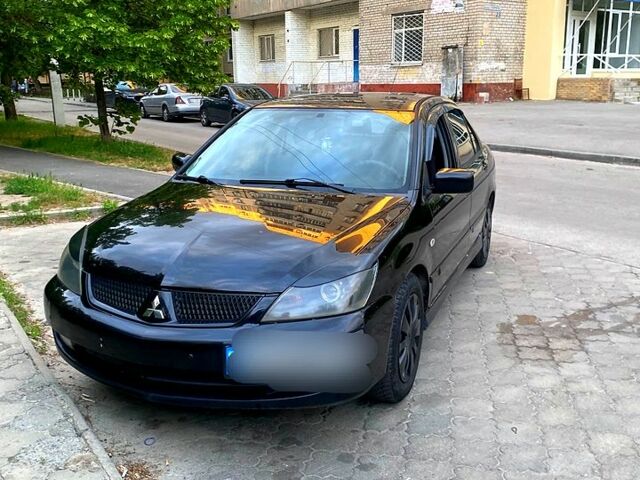 Черный Мицубиси Лансер, объемом двигателя 1.6 л и пробегом 235 тыс. км за 3750 $, фото 1 на Automoto.ua