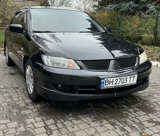 Черный Мицубиси Лансер, объемом двигателя 1.6 л и пробегом 300 тыс. км за 3400 $, фото 1 на Automoto.ua