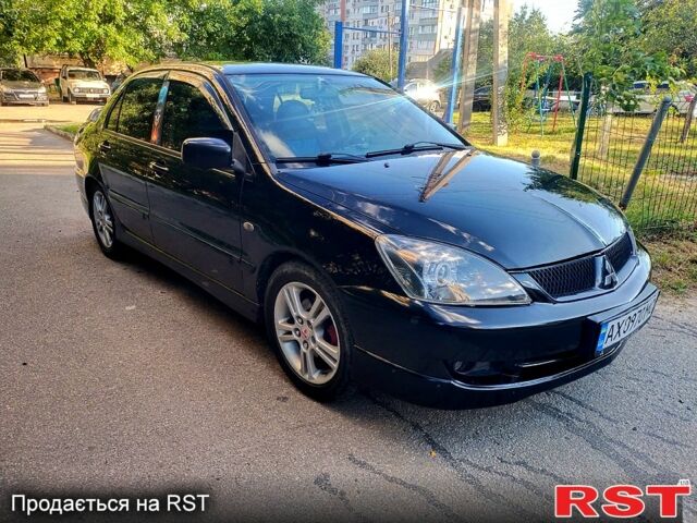 Черный Мицубиси Лансер, объемом двигателя 2 л и пробегом 200 тыс. км за 4450 $, фото 1 на Automoto.ua