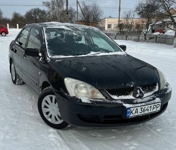 Чорний Міцубісі Lancer, об'ємом двигуна 1.6 л та пробігом 206 тис. км за 3700 $, фото 1 на Automoto.ua