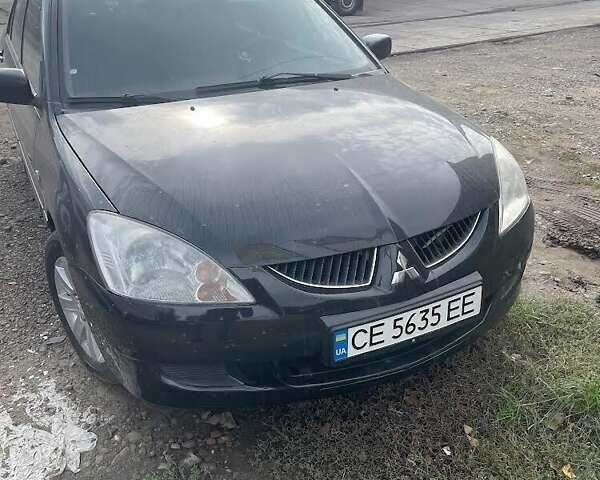 Черный Мицубиси Лансер, объемом двигателя 1.58 л и пробегом 200 тыс. км за 4000 $, фото 1 на Automoto.ua