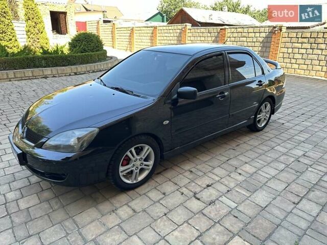 Черный Мицубиси Лансер, объемом двигателя 2 л и пробегом 272 тыс. км за 5514 $, фото 1 на Automoto.ua