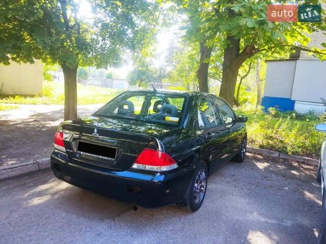 Черный Мицубиси Лансер, объемом двигателя 1.58 л и пробегом 255 тыс. км за 4000 $, фото 1 на Automoto.ua