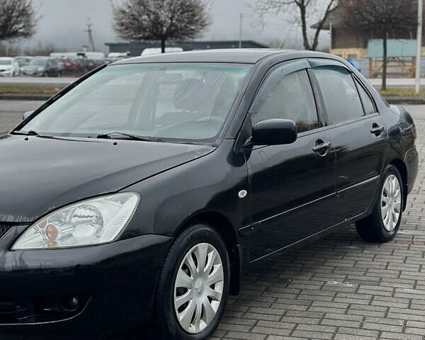 Черный Мицубиси Лансер, объемом двигателя 1.58 л и пробегом 346 тыс. км за 4000 $, фото 1 на Automoto.ua