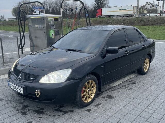 Черный Мицубиси Лансер, объемом двигателя 1.6 л и пробегом 200 тыс. км за 5000 $, фото 1 на Automoto.ua