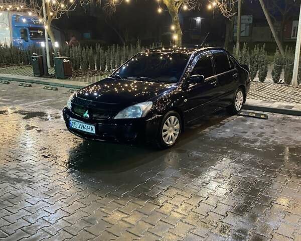 Черный Мицубиси Лансер, объемом двигателя 1.58 л и пробегом 285 тыс. км за 5100 $, фото 1 на Automoto.ua