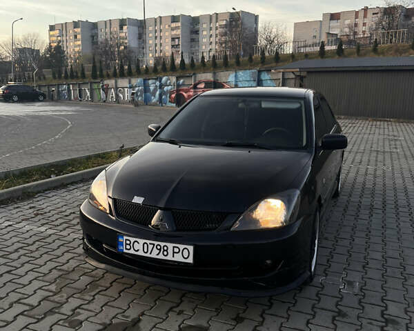 Черный Мицубиси Лансер, объемом двигателя 1.6 л и пробегом 245 тыс. км за 4300 $, фото 1 на Automoto.ua