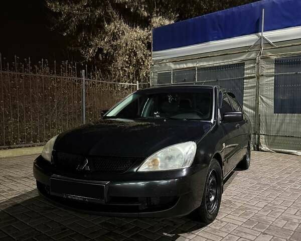 Черный Мицубиси Лансер, объемом двигателя 1.6 л и пробегом 305 тыс. км за 4200 $, фото 1 на Automoto.ua