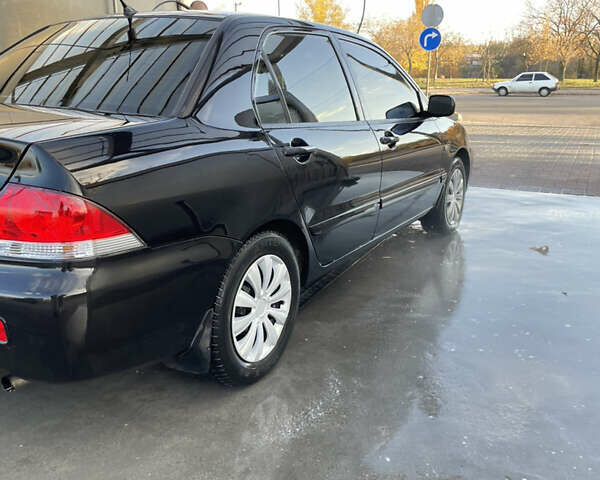 Черный Мицубиси Лансер, объемом двигателя 1.59 л и пробегом 348 тыс. км за 4200 $, фото 1 на Automoto.ua