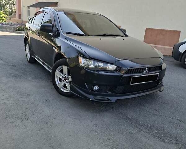 Черный Мицубиси Лансер, объемом двигателя 2 л и пробегом 230 тыс. км за 7000 $, фото 1 на Automoto.ua