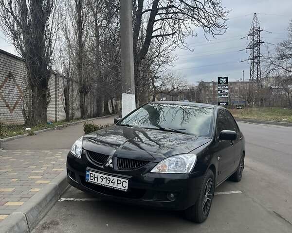 Черный Мицубиси Лансер, объемом двигателя 1.58 л и пробегом 211 тыс. км за 5500 $, фото 1 на Automoto.ua