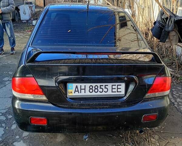 Черный Мицубиси Лансер, объемом двигателя 1.6 л и пробегом 140 тыс. км за 2500 $, фото 1 на Automoto.ua
