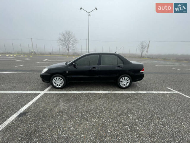 Черный Мицубиси Лансер, объемом двигателя 1.58 л и пробегом 214 тыс. км за 4400 $, фото 1 на Automoto.ua