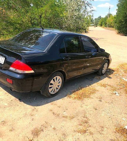 Чорний Міцубісі Lancer, об'ємом двигуна 1.6 л та пробігом 245 тис. км за 3200 $, фото 1 на Automoto.ua