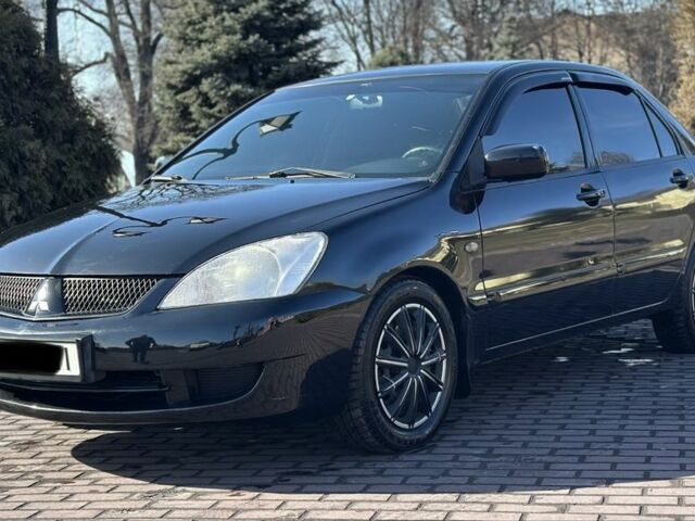 Черный Мицубиси Лансер, объемом двигателя 1.6 л и пробегом 200 тыс. км за 4500 $, фото 1 на Automoto.ua