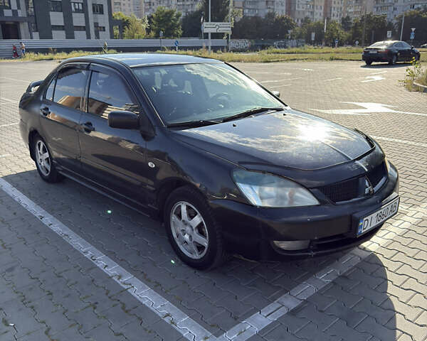 Черный Мицубиси Лансер, объемом двигателя 1.58 л и пробегом 364 тыс. км за 3000 $, фото 1 на Automoto.ua