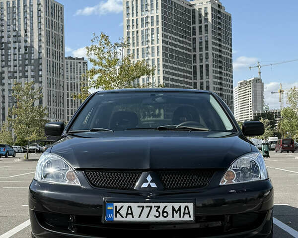 Черный Мицубиси Лансер, объемом двигателя 1.6 л и пробегом 321 тыс. км за 5000 $, фото 1 на Automoto.ua