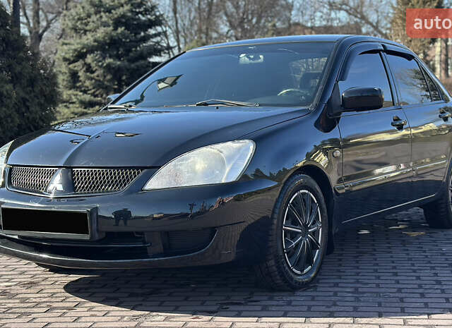 Черный Мицубиси Лансер, объемом двигателя 1.6 л и пробегом 200 тыс. км за 4500 $, фото 1 на Automoto.ua