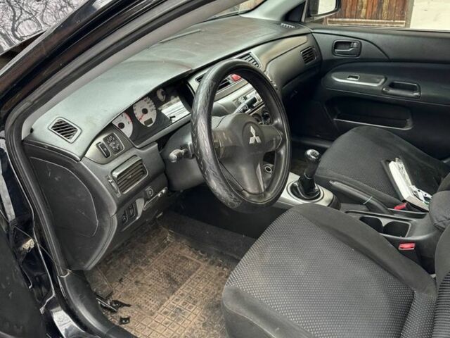 Черный Мицубиси Лансер, объемом двигателя 1.6 л и пробегом 190 тыс. км за 1500 $, фото 1 на Automoto.ua