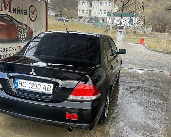 Чорний Міцубісі Lancer, об'ємом двигуна 1.59 л та пробігом 309 тис. км за 3900 $, фото 1 на Automoto.ua