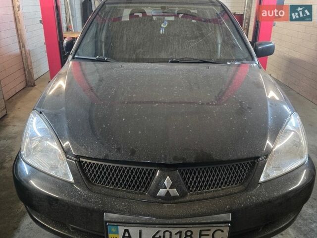 Черный Мицубиси Лансер, объемом двигателя 1.6 л и пробегом 289 тыс. км за 2500 $, фото 1 на Automoto.ua