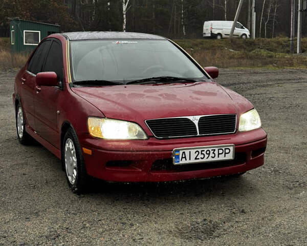 Красный Мицубиси Лансер, объемом двигателя 2 л и пробегом 202 тыс. км за 2599 $, фото 1 на Automoto.ua