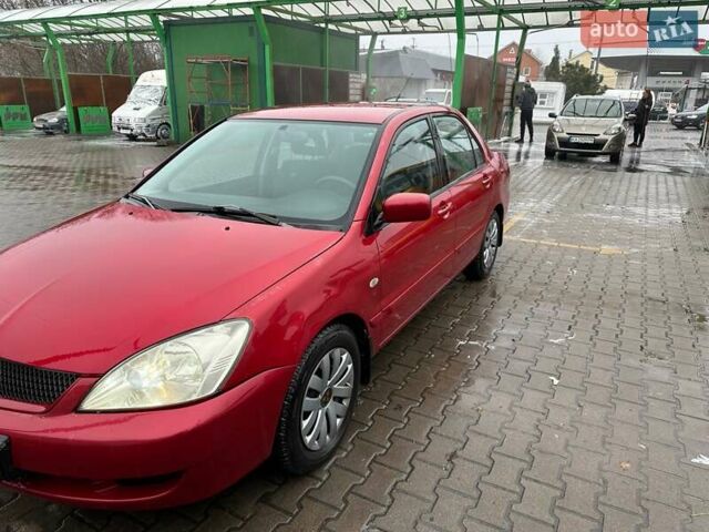 Красный Мицубиси Лансер, объемом двигателя 1.6 л и пробегом 185 тыс. км за 5000 $, фото 1 на Automoto.ua