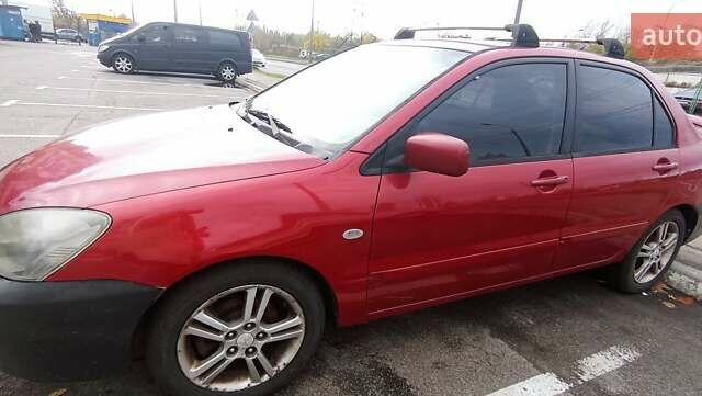 Красный Мицубиси Лансер, объемом двигателя 2 л и пробегом 320 тыс. км за 4600 $, фото 1 на Automoto.ua