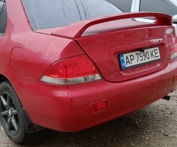 Красный Мицубиси Лансер, объемом двигателя 1.6 л и пробегом 155 тыс. км за 2000 $, фото 1 на Automoto.ua