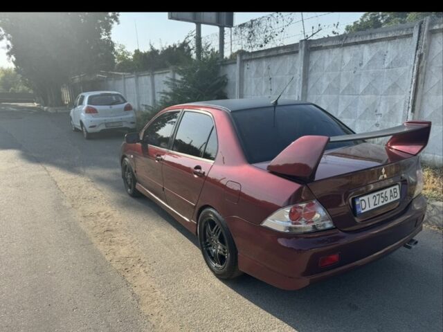 Красный Мицубиси Лансер, объемом двигателя 2 л и пробегом 3 тыс. км за 5800 $, фото 1 на Automoto.ua