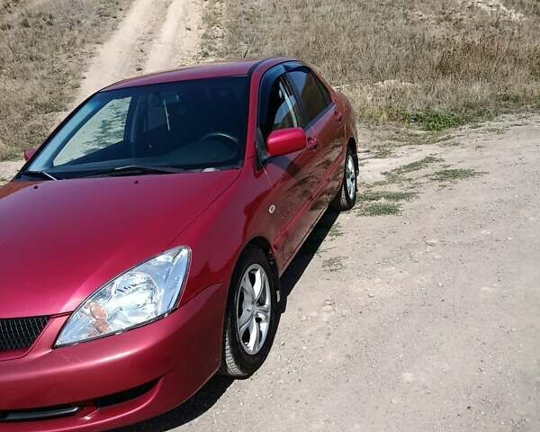 Червоний Міцубісі Lancer, об'ємом двигуна 1.6 л та пробігом 246 тис. км за 5500 $, фото 1 на Automoto.ua