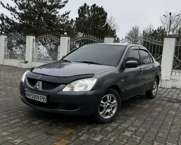 Серый Мицубиси Лансер, объемом двигателя 1.58 л и пробегом 320 тыс. км за 4150 $, фото 1 на Automoto.ua