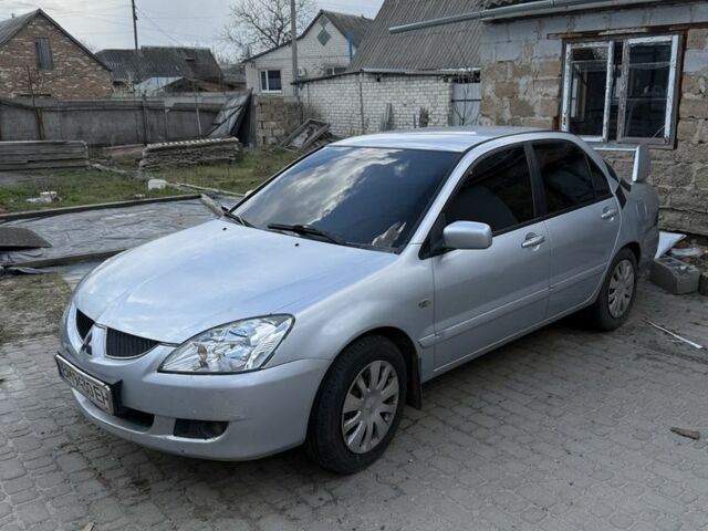 Серый Мицубиси Лансер, объемом двигателя 1.6 л и пробегом 300 тыс. км за 3600 $, фото 1 на Automoto.ua