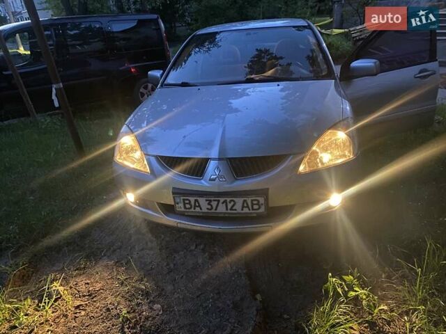 Серый Мицубиси Лансер, объемом двигателя 1.58 л и пробегом 230 тыс. км за 5250 $, фото 1 на Automoto.ua