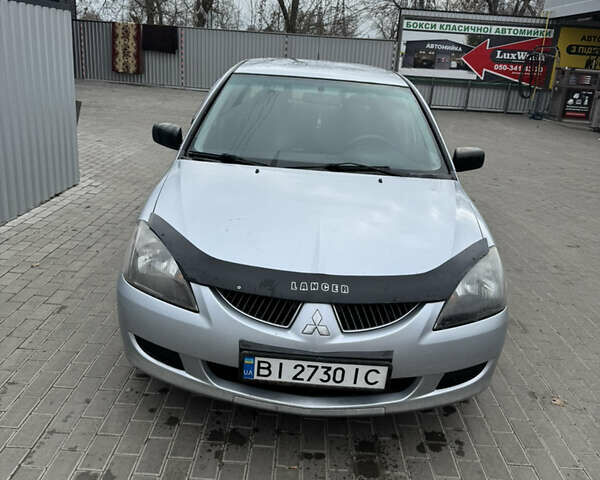 Серый Мицубиси Лансер, объемом двигателя 1.58 л и пробегом 260 тыс. км за 3500 $, фото 1 на Automoto.ua