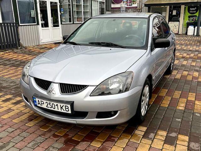 Серый Мицубиси Лансер, объемом двигателя 1.6 л и пробегом 236 тыс. км за 3800 $, фото 1 на Automoto.ua