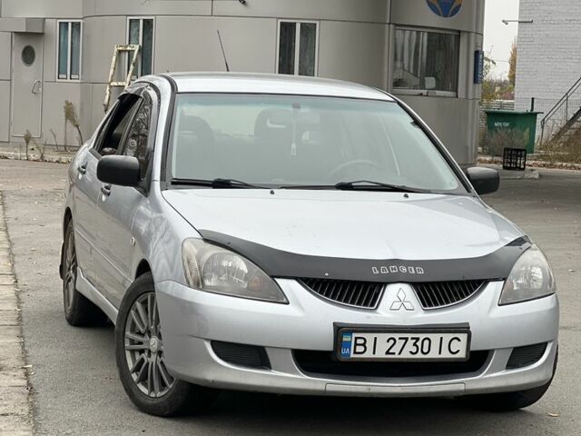 Серый Мицубиси Лансер, объемом двигателя 1.6 л и пробегом 250 тыс. км за 2600 $, фото 1 на Automoto.ua