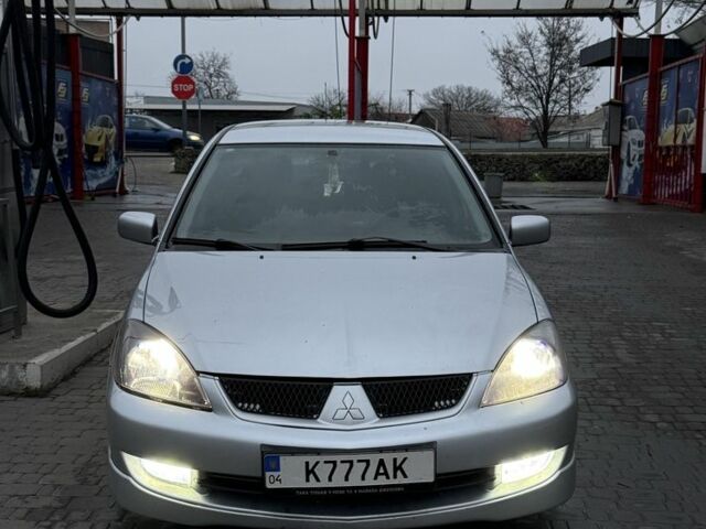 Серый Мицубиси Лансер, объемом двигателя 2 л и пробегом 256 тыс. км за 7000 $, фото 1 на Automoto.ua