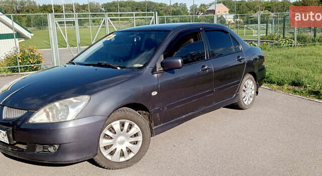 Серый Мицубиси Лансер, объемом двигателя 1.58 л и пробегом 300 тыс. км за 4400 $, фото 1 на Automoto.ua