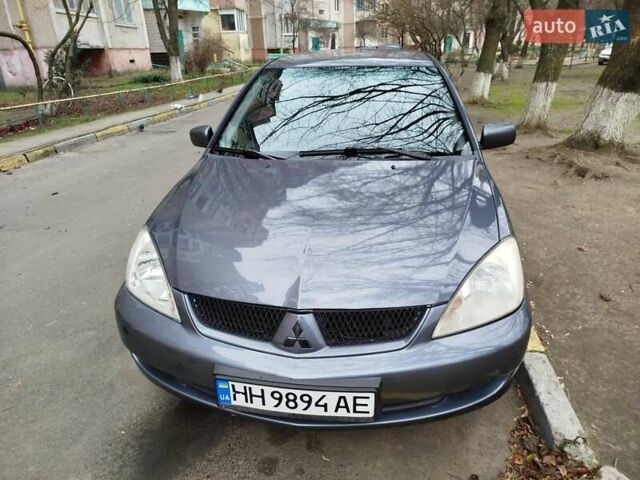 Сірий Міцубісі Lancer, об'ємом двигуна 1.58 л та пробігом 250 тис. км за 4750 $, фото 1 на Automoto.ua