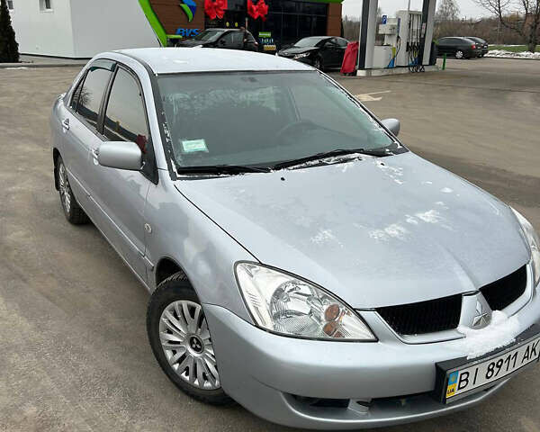 Серый Мицубиси Лансер, объемом двигателя 1.6 л и пробегом 150 тыс. км за 5300 $, фото 1 на Automoto.ua