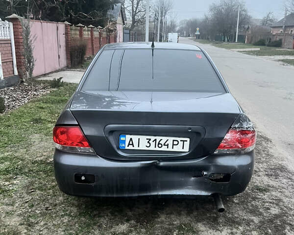 Сірий Міцубісі Lancer, об'ємом двигуна 1.58 л та пробігом 186 тис. км за 3500 $, фото 1 на Automoto.ua