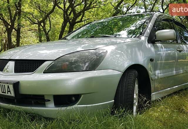 Серый Мицубиси Лансер, объемом двигателя 2 л и пробегом 150 тыс. км за 5650 $, фото 1 на Automoto.ua