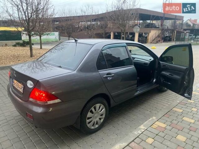 Серый Мицубиси Лансер, объемом двигателя 1.6 л и пробегом 245 тыс. км за 3800 $, фото 1 на Automoto.ua