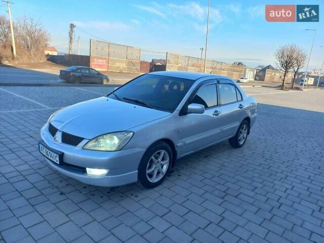 Серый Мицубиси Лансер, объемом двигателя 1.6 л и пробегом 228 тыс. км за 2999 $, фото 1 на Automoto.ua
