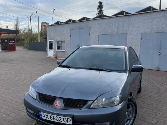 Серый Мицубиси Лансер, объемом двигателя 1.6 л и пробегом 318 тыс. км за 3800 $, фото 1 на Automoto.ua