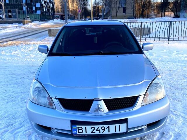 Серый Мицубиси Лансер, объемом двигателя 1.6 л и пробегом 24300 тыс. км за 4999 $, фото 1 на Automoto.ua